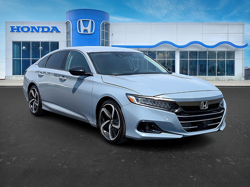 The same Honda sedan presented in front of a branded dealership scene.