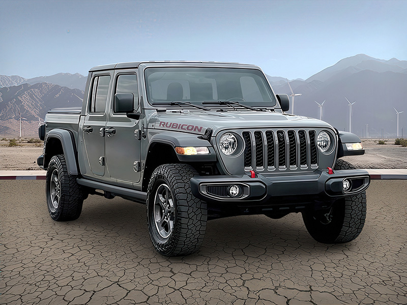The same Jeep pickup presented against a mountain landscape.