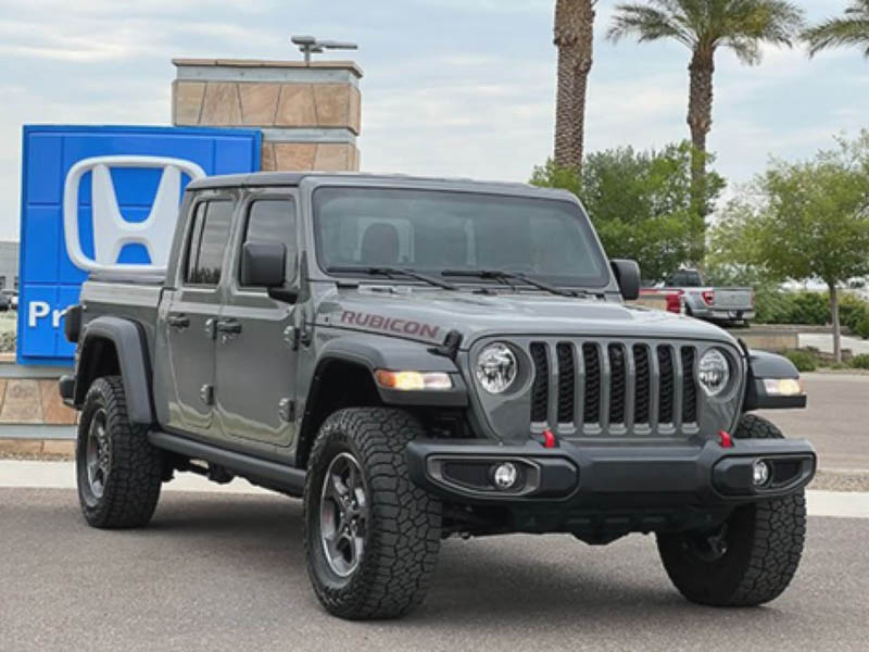 Original gray Jeep pickup photographed on the lot.